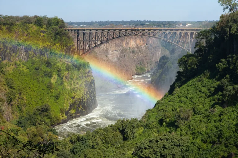 Rainbow arcing over the Zambezi River and the spray of Victoria Falls