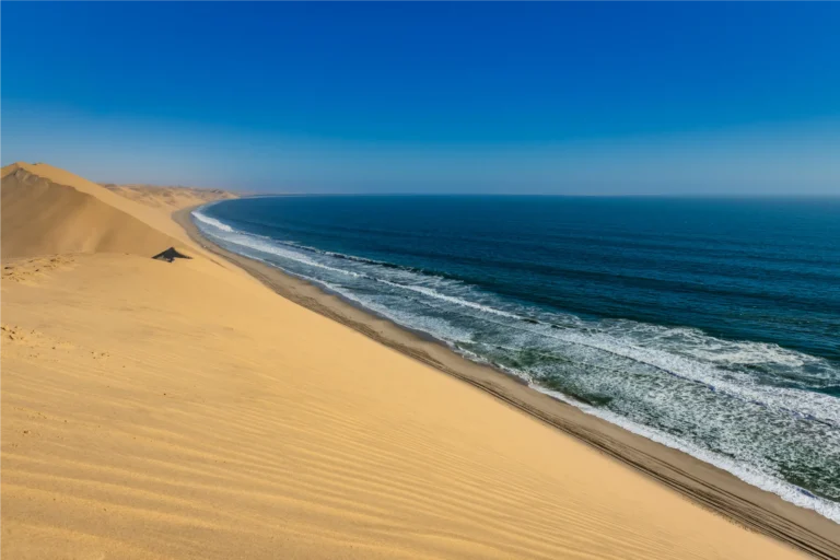 Sand dunes meeting the Atlantic Ocean at Skeleton Coast National Park, Namibia
